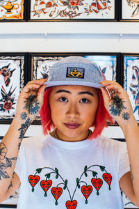 DEEDS NOT WORDS 5-PANEL HAT